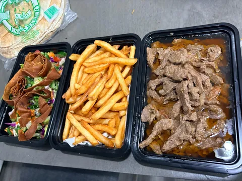 Individual containers with meat, fries and stuffed bread.