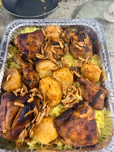 A generous tray of roasted chicken over rice.