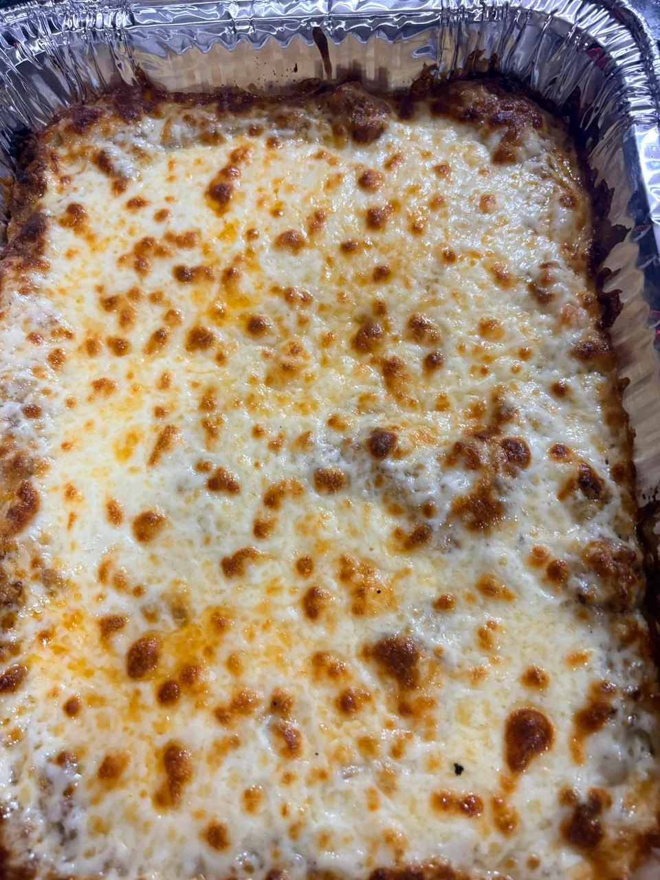 A large baked dish with a golden browned topping.