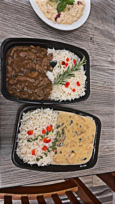 Prepared individual portions of rice and two different stews.