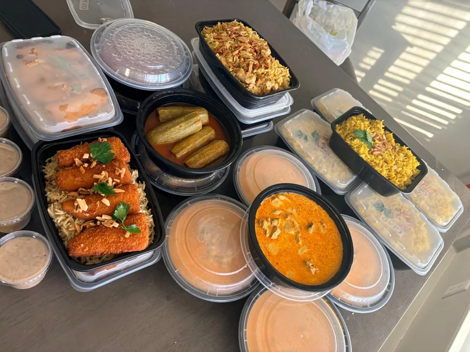 A dining table filled with assorted meals, stews and side dishes.