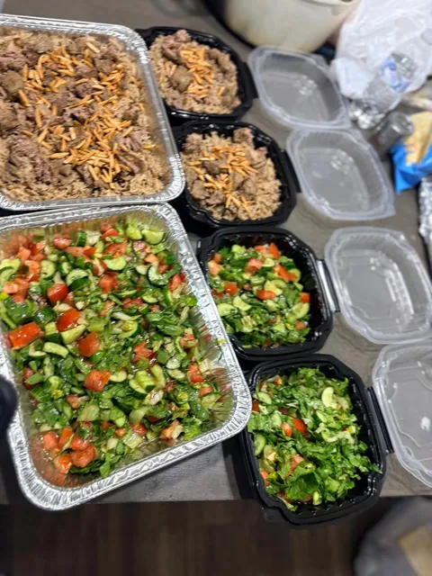 Large rice and salad trays surrounded by individual portions.