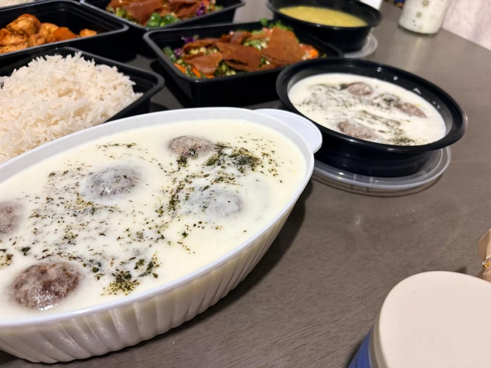 Individual portions of home-cooked dishes including rice and creamy stews.