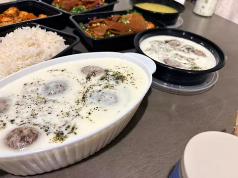 Individual portions of home-cooked dishes including rice and creamy stews.