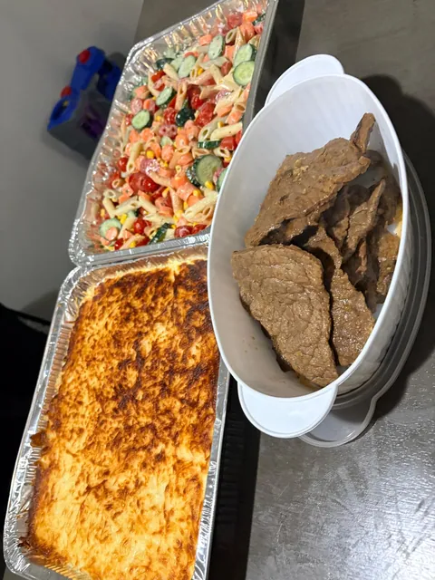 A baked dish, fresh salad and a plate of browned savory pieces.