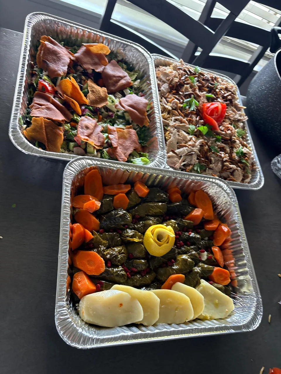 Several meals with roasted chicken, rice and stuffed vegetables.